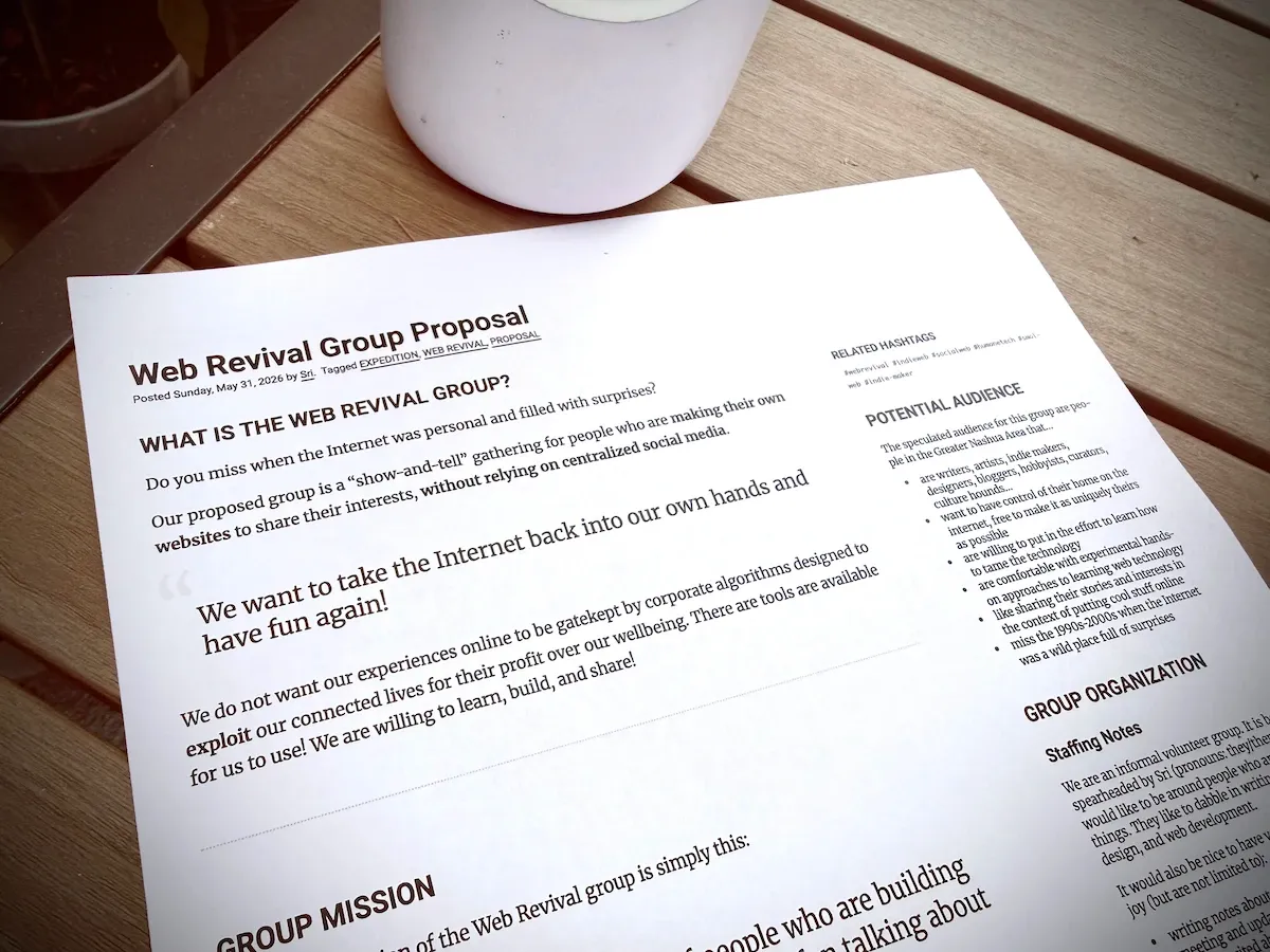 Printed documented titled "Web Revival Group Proposal" lying on a table. The headline reads "What is the Web Revival Group"